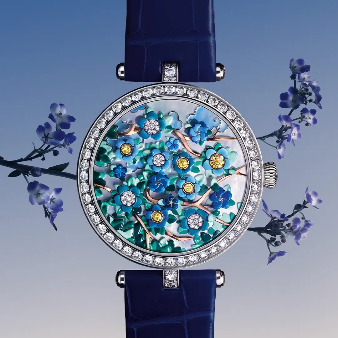 Watch from the poetic complication collection on purple background with blue flowers 