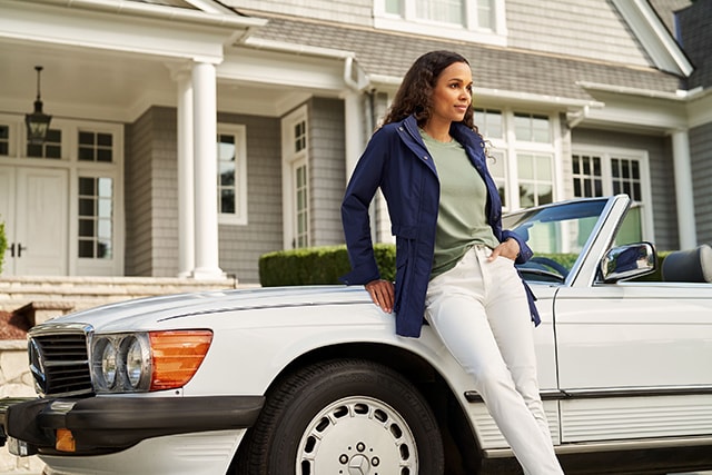 Female model sitting on the hood of a vintage car-Peter Millar-Richemont Group