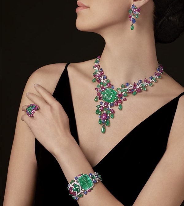Woman wearing a bracelet, necklace, earrings and ring from the Tutti Frutti collection by Cartier