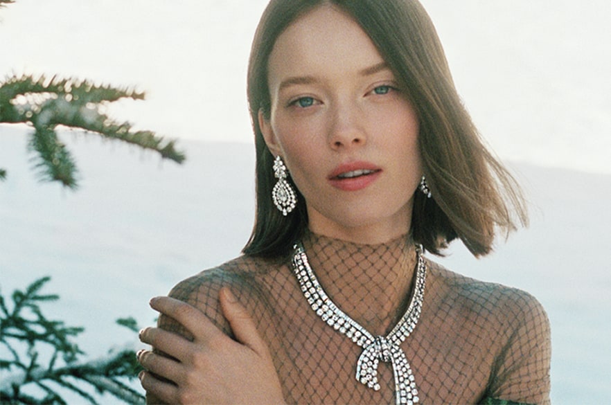 Woman wearing Van Cleef & Arpels earrings and necklace