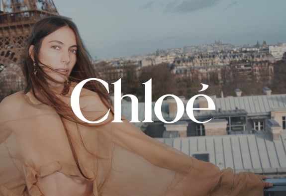 Chloé logo with a woman in airy dress and Paris in the background
