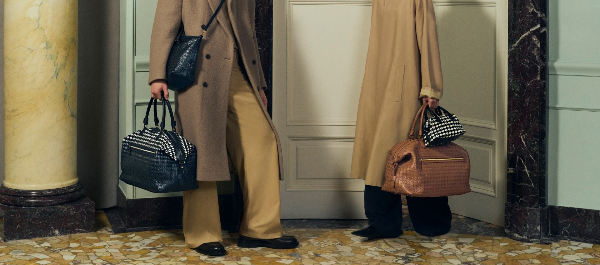 A pair of people holding Serapian bags