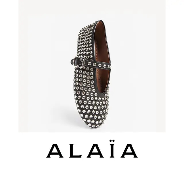 A black shoe encrusted with studs