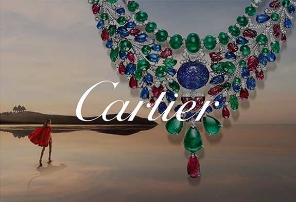 Cartier logo with Tutti Frutti necklace in the background