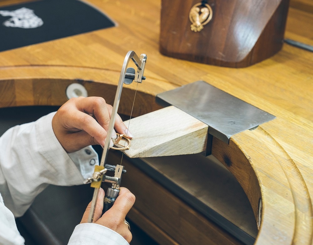 A person working on a jewellery piece in a workshop