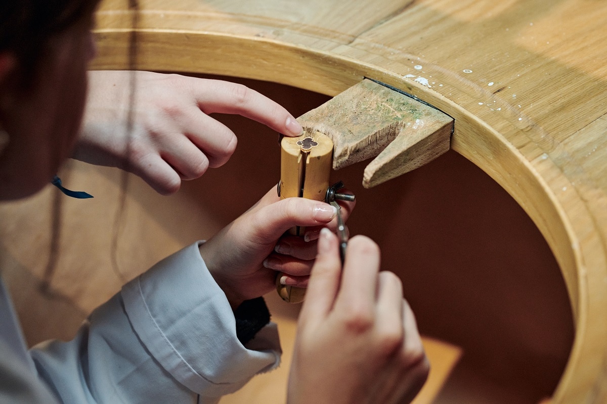 A person working on a jewellery piece in a workshop