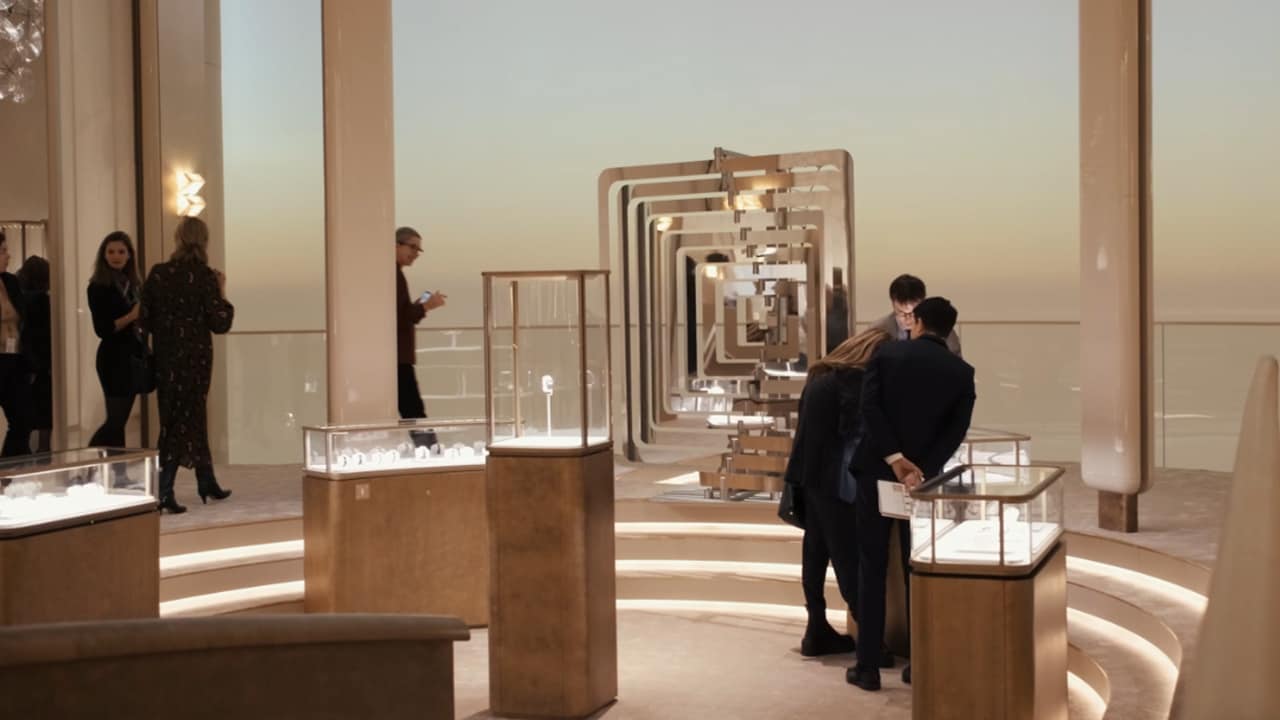 Visitors examining the watches in a exhibition room